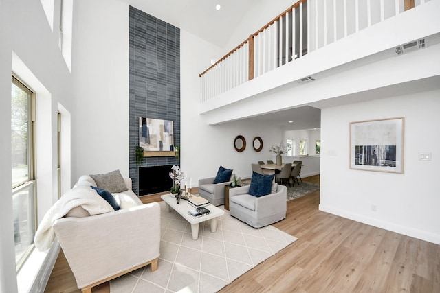 300 Narcissus Rd, Clear Lake Shores, TX 77565 - living area with a towering ceiling, baseboards, visible vents, and wood finished floors