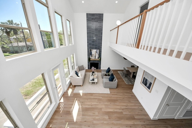 300 Narcissus Rd, Clear Lake Shores, TX 77565 - living area with high vaulted ceiling, recessed lighting, a brick fireplace, and wood finished floors