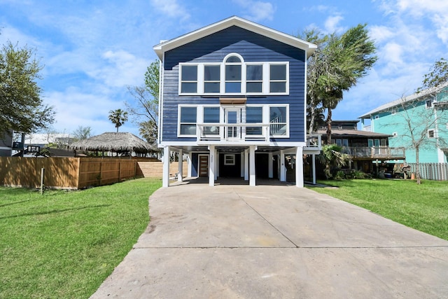 300 Narcissus Rd, Clear Lake Shores, TX 77565 - coastal inspired home featuring a carport, driveway, a front yard, and fence