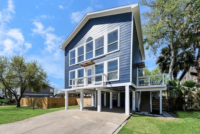 300 Narcissus Rd, Clear Lake Shores, TX 77565 - view of front of home with a carport, concrete driveway, fence, and a front lawn