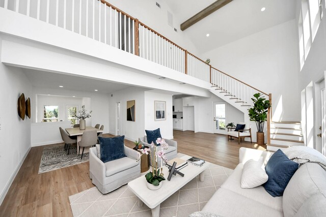 300 Narcissus Rd, Clear Lake Shores, TX 77565 - living area featuring a high ceiling, beamed ceiling, recessed lighting, stairway, and wood finished floors