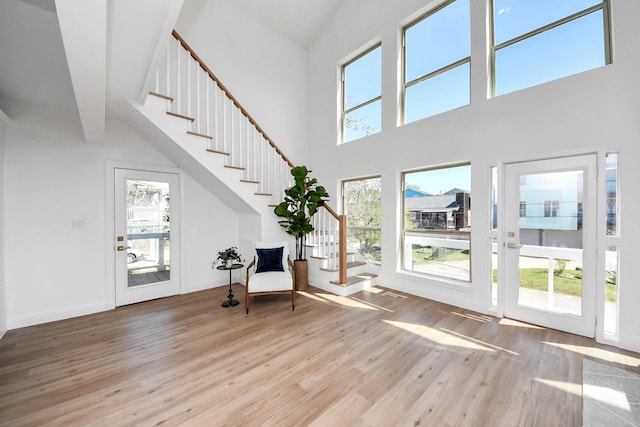 300 Narcissus Rd, Clear Lake Shores, TX 77565 - unfurnished room featuring high vaulted ceiling, wood finished floors, and stairs