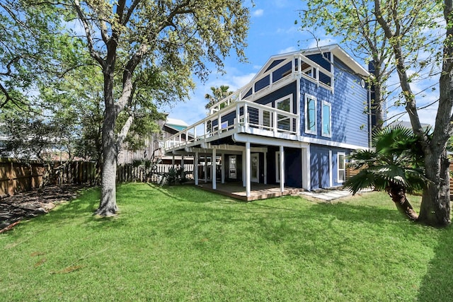 300 Narcissus Rd, Clear Lake Shores, TX 77565 - rear view of house featuring a wooden deck, fence, and a lawn