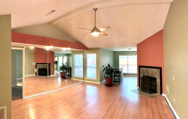 living room with a fireplace with flush hearth, wood finished floors, baseboards, and a ceiling fan