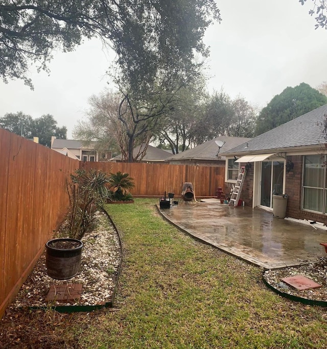 view of yard with a patio area and a fenced backyard