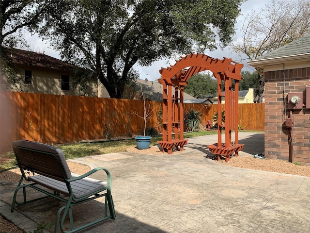 view of patio / terrace featuring a fenced backyard and a pergola