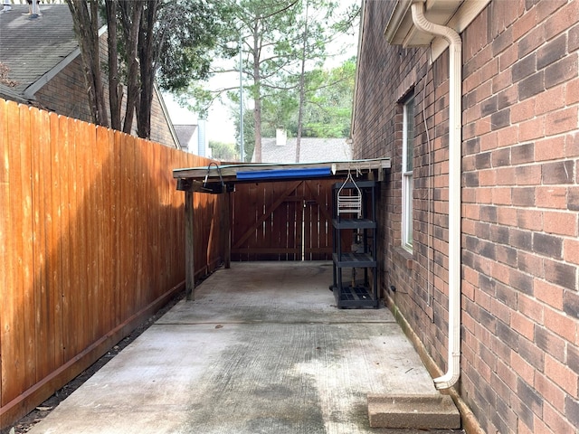 view of home's exterior featuring fence and brick siding