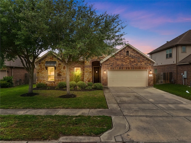 321 Westwood Dr, League City, TX 77573 - view of front of property with an attached garage, concrete driveway, a front yard, and stone siding