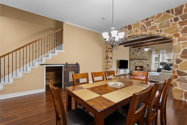 321 Westwood Dr, League City, TX 77573 - dining space featuring a ceiling fan, wood finished floors, a stone fireplace, a chandelier, and baseboards