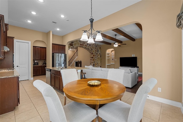 321 Westwood Dr, League City, TX 77573 - dining area with arched walkways, light tile patterned floors, ceiling fan, stairway, and beamed ceiling