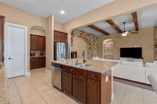 321 Westwood Dr, League City, TX 77573 - kitchen with stainless steel appliances, a sink, arched walkways, light tile patterned floors, and a ceiling fan