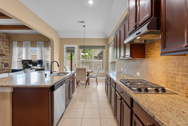 321 Westwood Dr, League City, TX 77573 - kitchen with appliances with stainless steel finishes, under cabinet range hood, a sink, backsplash, and hanging light fixtures