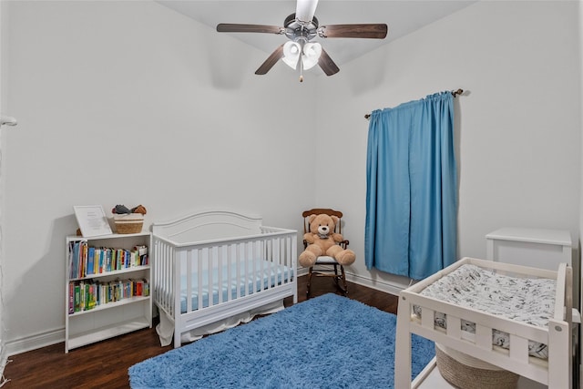 321 Westwood Dr, League City, TX 77573 - bedroom with wood finished floors, a crib, baseboards, and ceiling fan