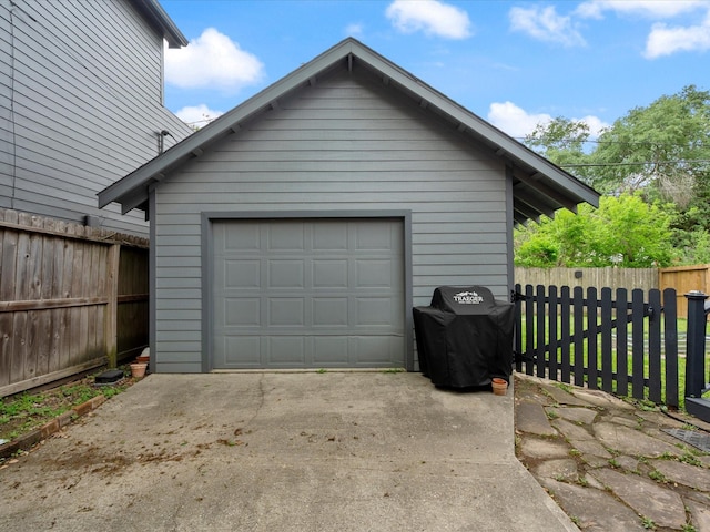 824 Sledge St, Houston, TX 77009 - garage featuring concrete driveway and fence