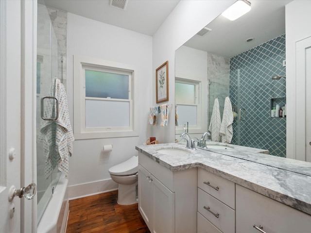 824 Sledge St, Houston, TX 77009 - full bathroom featuring wood finished floors, toilet, vanity, and baseboards