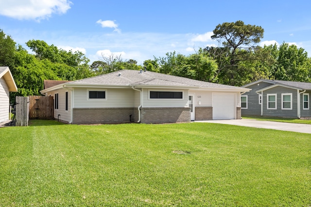 view of front facade featuring a garage, a front yard, fence, brick siding, and driveway