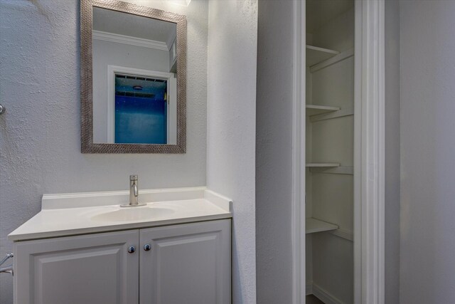 3535 Nasa Rd 1St Pkwy, Unit 36, Seabrook, TX 77586 - bathroom featuring a textured wall, vanity, and ornamental molding