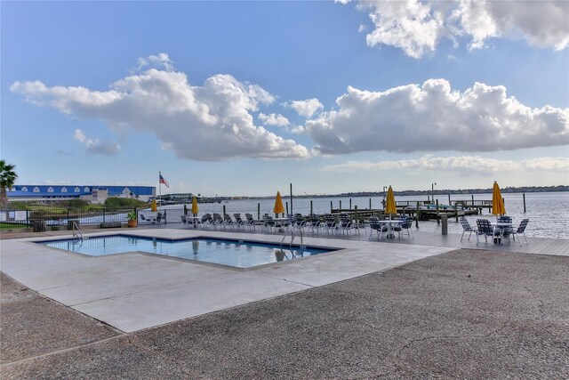 3535 Nasa Rd 1St Pkwy, Unit 36, Seabrook, TX 77586 - view of swimming pool with a patio area, fence, a boat dock, and a water view