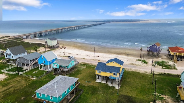 drone / aerial view featuring a water view and a view of the beach