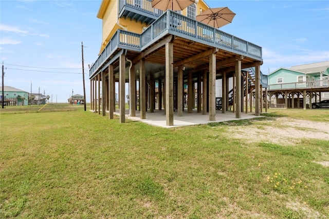rear view of house with a lawn, a deck, and stairs