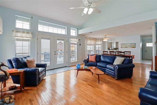 living area featuring french doors, a ceiling fan, hardwood / wood-style flooring, and lofted ceiling