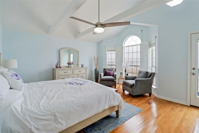 bedroom featuring a ceiling fan, baseboards, lofted ceiling with beams, and light wood-style floors