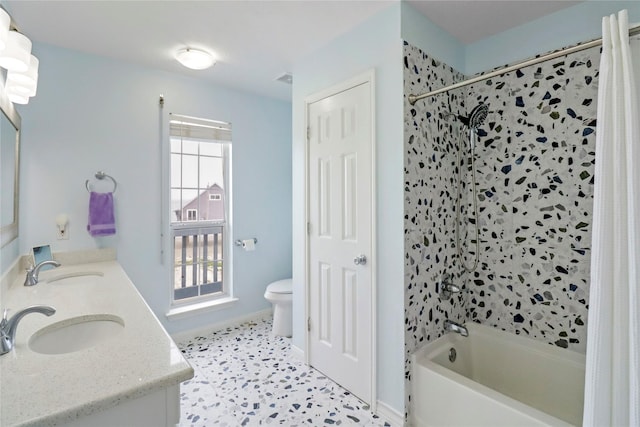bathroom with a sink, shower / bath combo with shower curtain, toilet, and double vanity