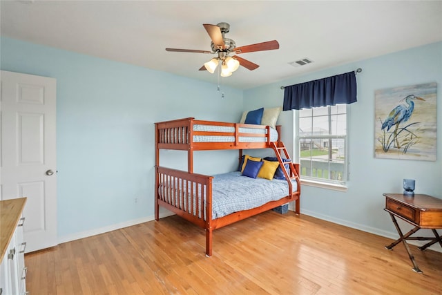 bedroom with baseboards, light wood-style flooring, and visible vents