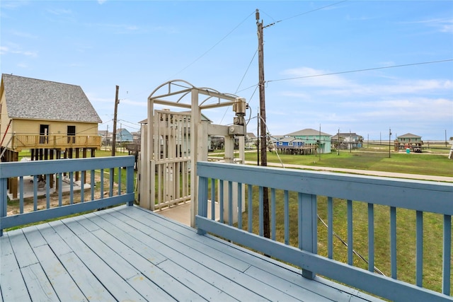 wooden deck featuring a yard and a residential view