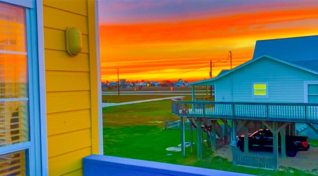 playground at dusk with a yard and a deck
