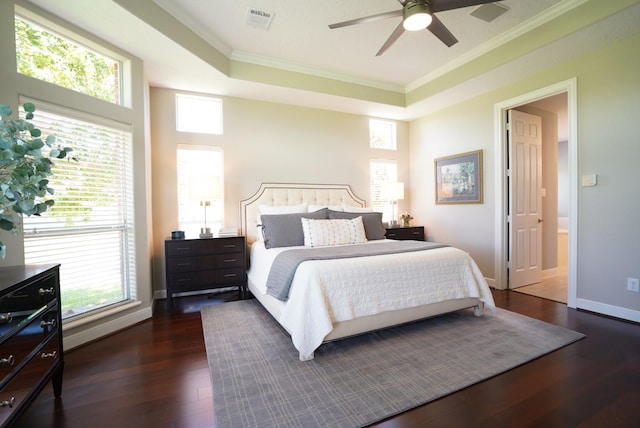 bedroom with visible vents, multiple windows, ornamental molding, and dark wood finished floors