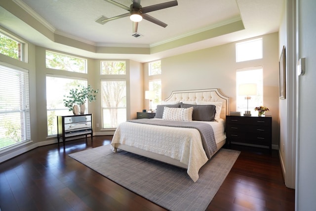 bedroom featuring crown molding, visible vents, and a raised ceiling