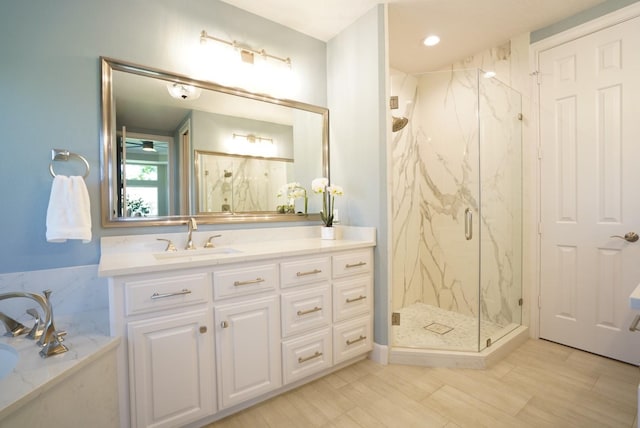 bathroom featuring vanity, a bath, and a marble finish shower
