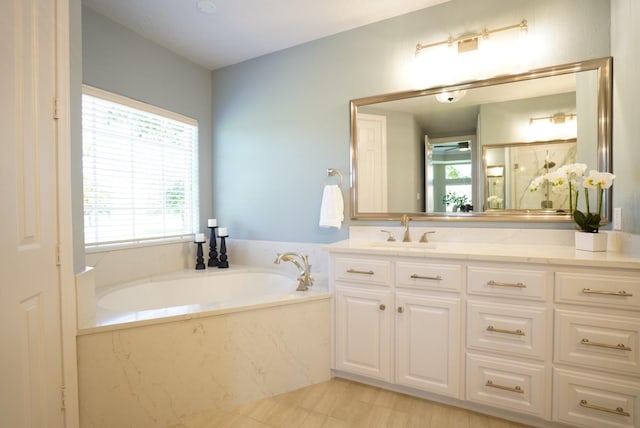 full bath featuring an enclosed shower, a bath, and vanity