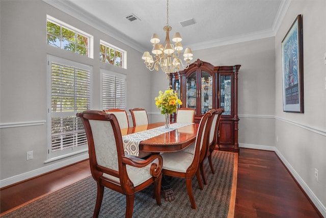 dining area with ornamental molding, visible vents, an inviting chandelier, and wood finished floors
