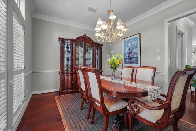dining room featuring an inviting chandelier, crown molding, and wood finished floors