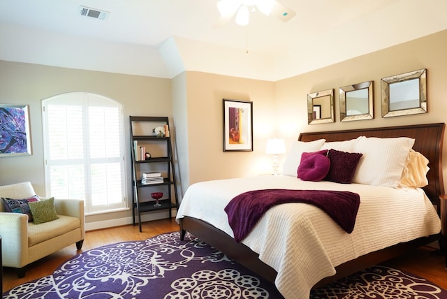 bedroom with visible vents, a ceiling fan, and wood finished floors