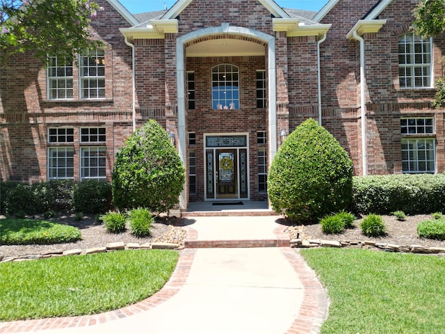 entrance to property featuring brick siding