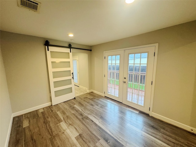 3060 Noble St, Houston, TX 77026 - interior space with french doors, visible vents, baseboards, and a barn door
