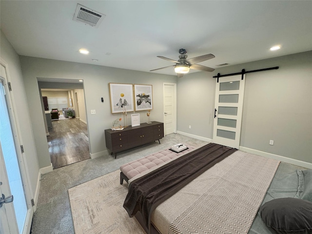 3060 Noble St, Houston, TX 77026 - bedroom featuring carpet flooring, a barn door, visible vents, and baseboards