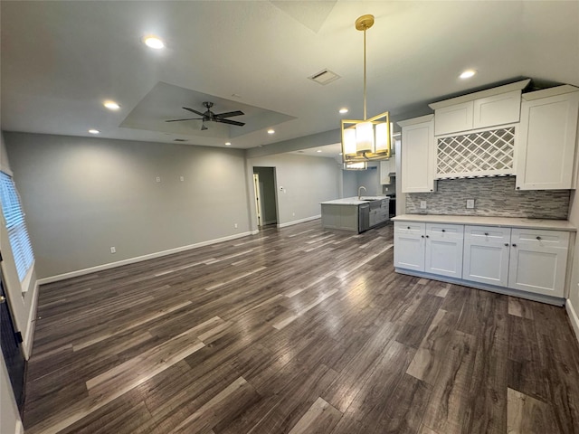 3060 Noble St, Houston, TX 77026 - kitchen with ceiling fan, visible vents, light countertops, baseboards, and dark wood-style floors