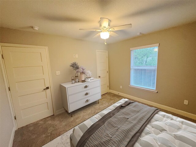 3060 Noble St, Houston, TX 77026 - bedroom with light carpet, baseboards, and a ceiling fan