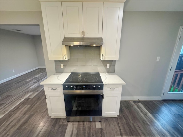 3060 Noble St, Houston, TX 77026 - kitchen featuring baseboards, light stone counters, electric range, under cabinet range hood, and dark wood finished floors