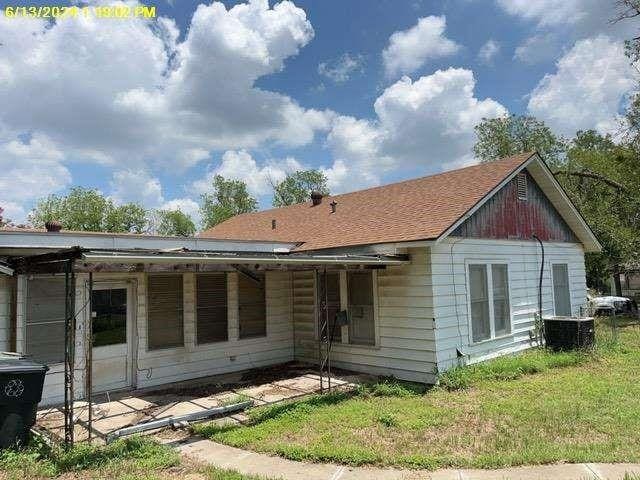 1302 S 23rd St, Temple, TX 76504 - rear view of house featuring central AC unit and a lawn