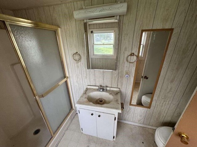 1302 S 23rd St, Temple, TX 76504 - bathroom with toilet, a stall shower, wood walls, and vanity