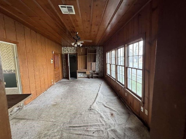 1302 S 23rd St, Temple, TX 76504 - interior space featuring light carpet, wooden walls, a ceiling fan, visible vents, and wood ceiling