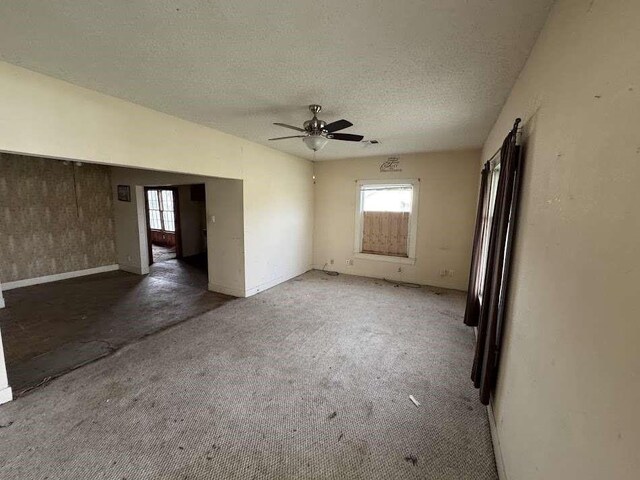 1302 S 23rd St, Temple, TX 76504 - carpeted empty room with a textured ceiling, ceiling fan, and baseboards