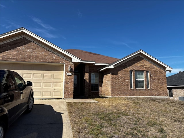 301 Hedy Dr, Killeen, TX 76542 - ranch-style house with brick siding, a front yard, driveway, and a garage