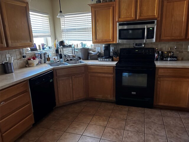 301 Hedy Dr, Killeen, TX 76542 - kitchen featuring black appliances, backsplash, a sink, and light countertops