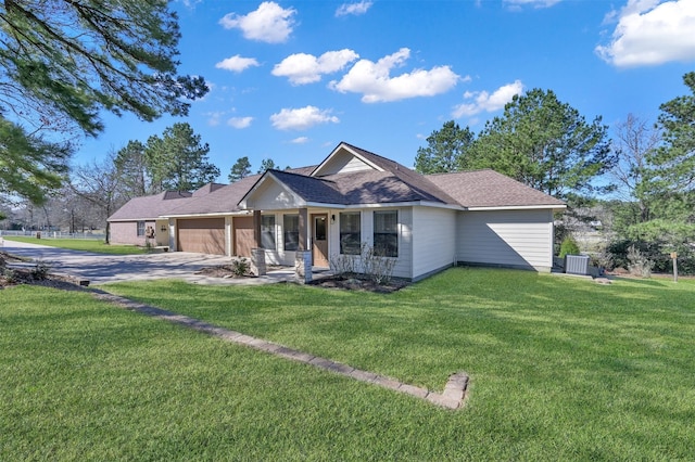 11445 Majestic Dr, Montgomery, TX 77316 - view of front of house with an attached garage, central AC unit, a front yard, and concrete driveway